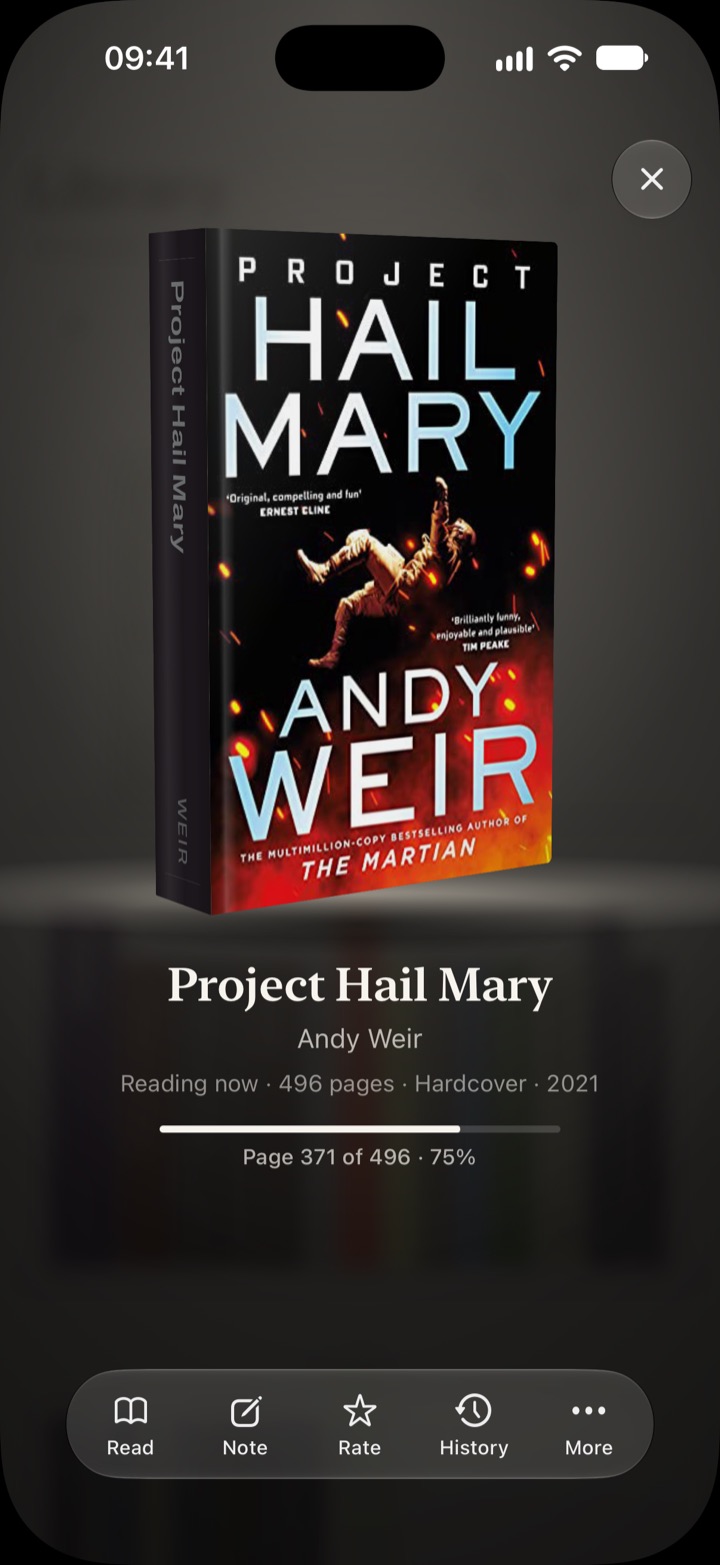 Project Hail Mary held up in a dark room, its cover facing you